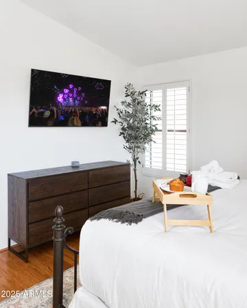 a bedroom with a bed and a flat screen tv