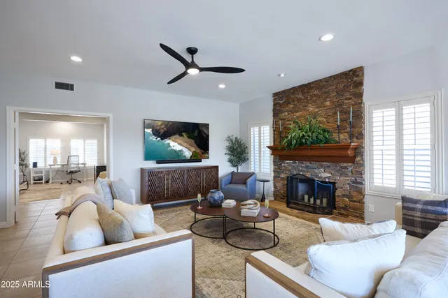 a living room with furniture and a fireplace