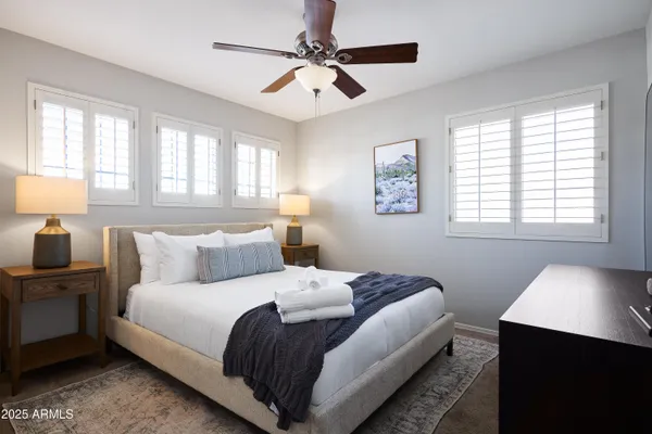 a bedroom with a bed and a lamp