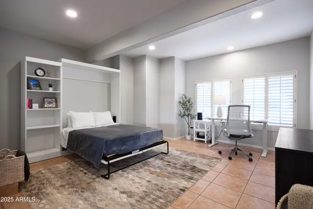 a living room with a bed furniture and a window