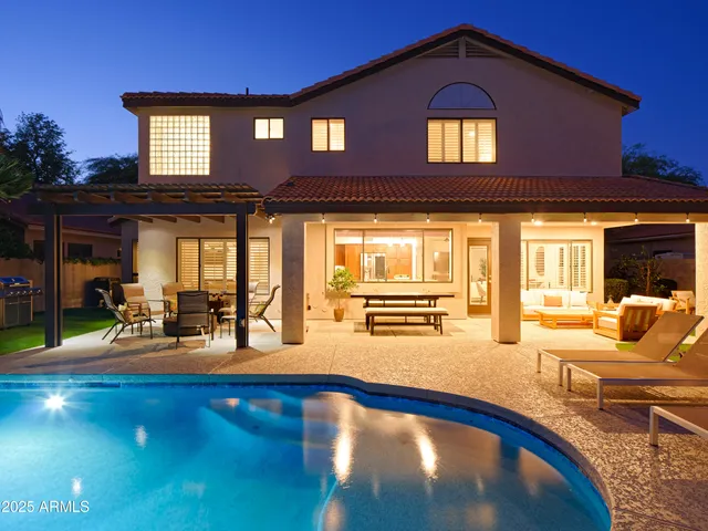 a view of a house with swimming pool and a yard