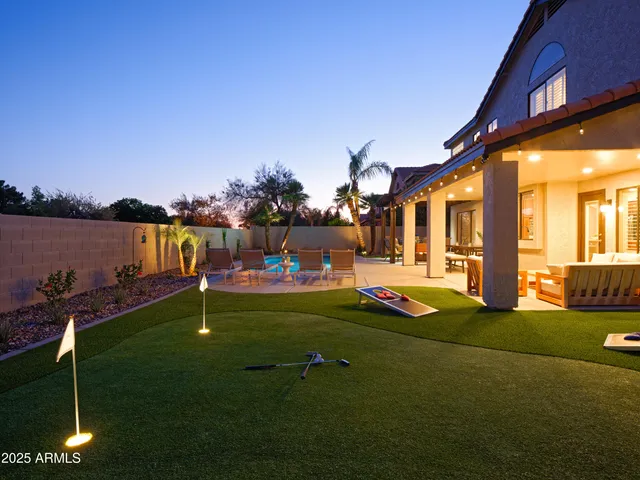 a terrace with outdoor seating and trees in the background