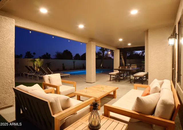 a view of a dining room with furniture a chandelier and wooden floor