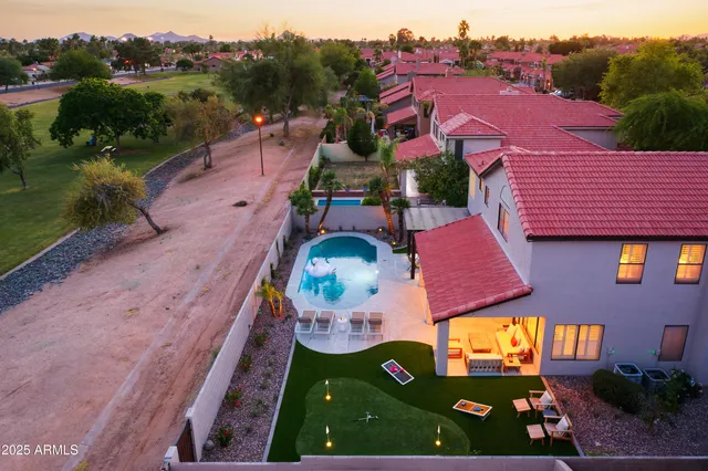 an aerial view of residential houses with outdoor space and parking
