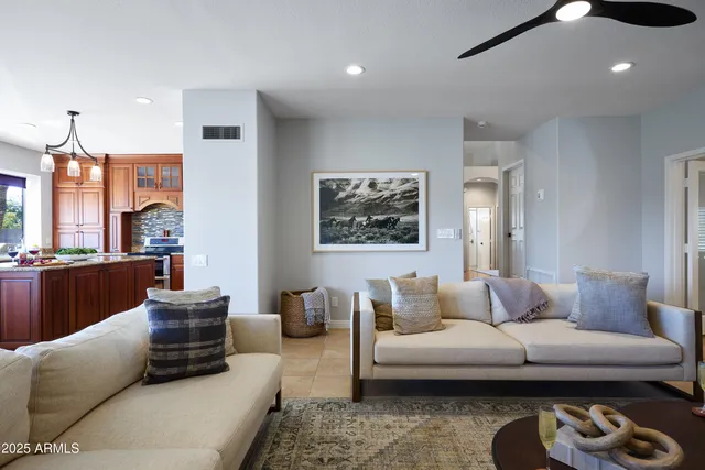 a living room with furniture a rug and a chandelier