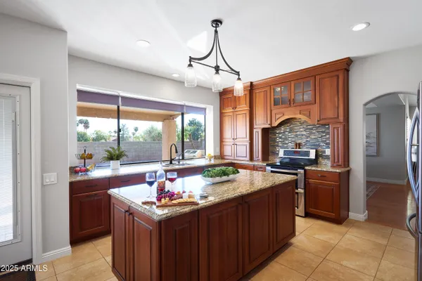 a kitchen with a stove sink and refrigerator