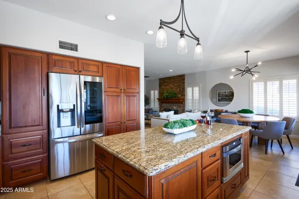 a kitchen with stainless steel appliances granite countertop a stove and refrigerator