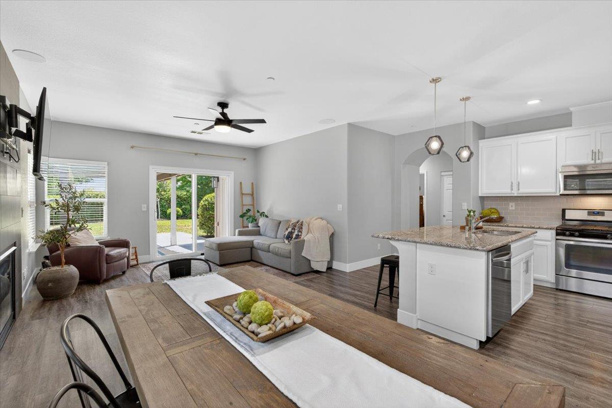 437 Silver Ridge Court Oakdale, CA 95361 - Photo 14 of 41 a living room with kitchen island furniture and a large window