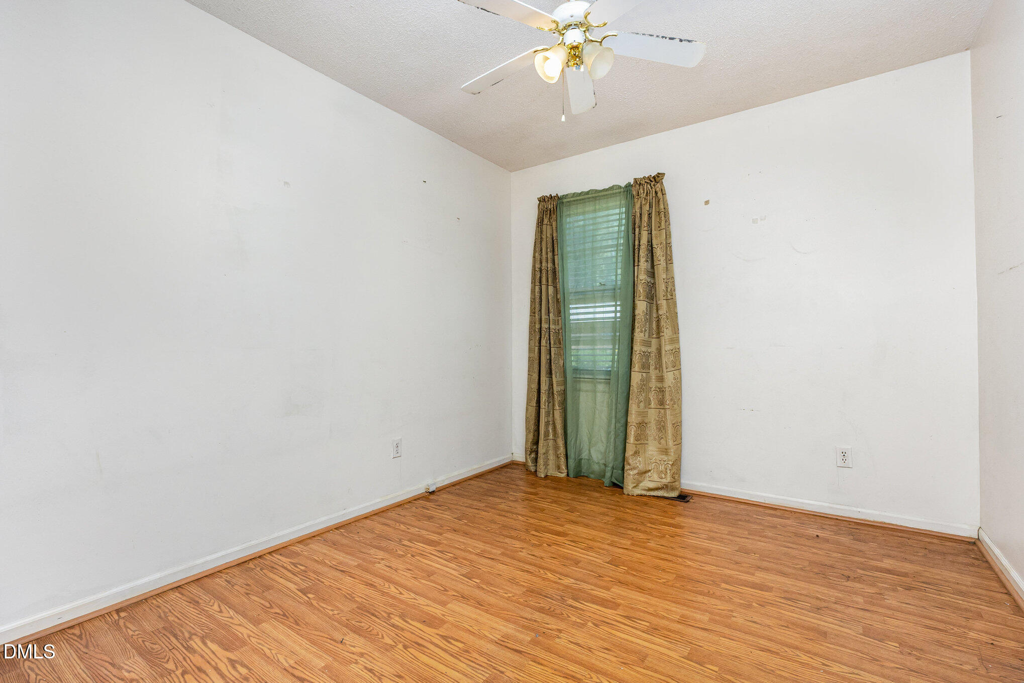 2111 Fieldcrest Road East Wilson, NC 27893 - Photo 16 of 37 an empty room with wooden floor and fan