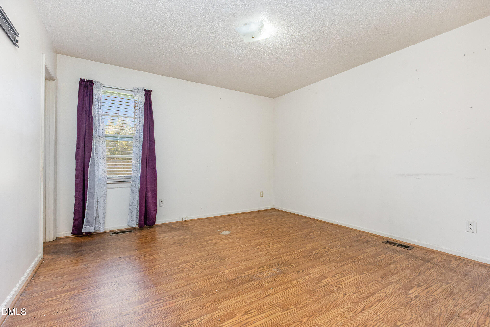 2111 Fieldcrest Road East Wilson, NC 27893 - Photo 22 of 37 an empty room with wooden floor and windows