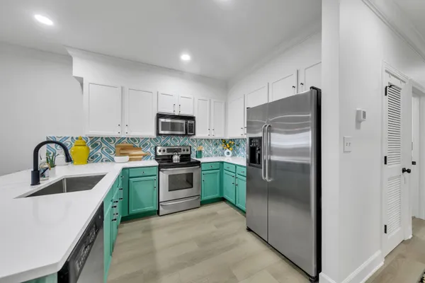 a kitchen with a refrigerator sink and stainless steel appliances