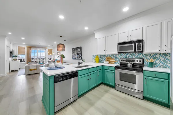 a kitchen with sink cabinets and stainless steel appliances