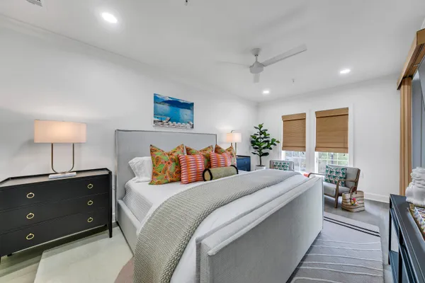 a bedroom with a large bed and a lamp