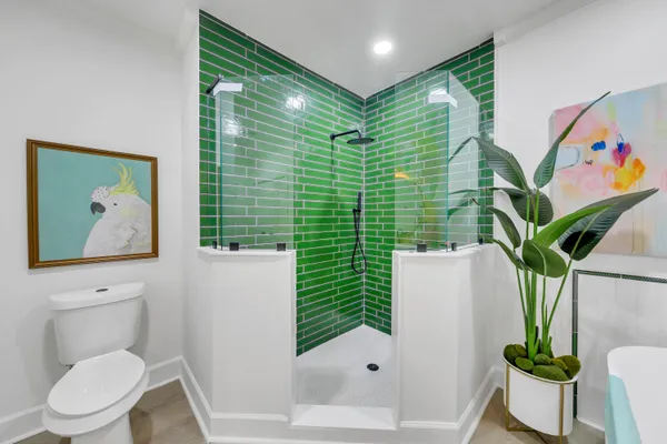 a bathroom with a toilet and a shower