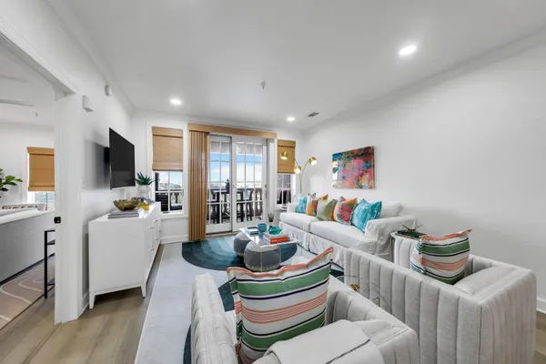 a living room with furniture and a wooden floor