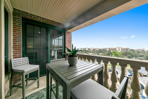 a view of a balcony with chairs