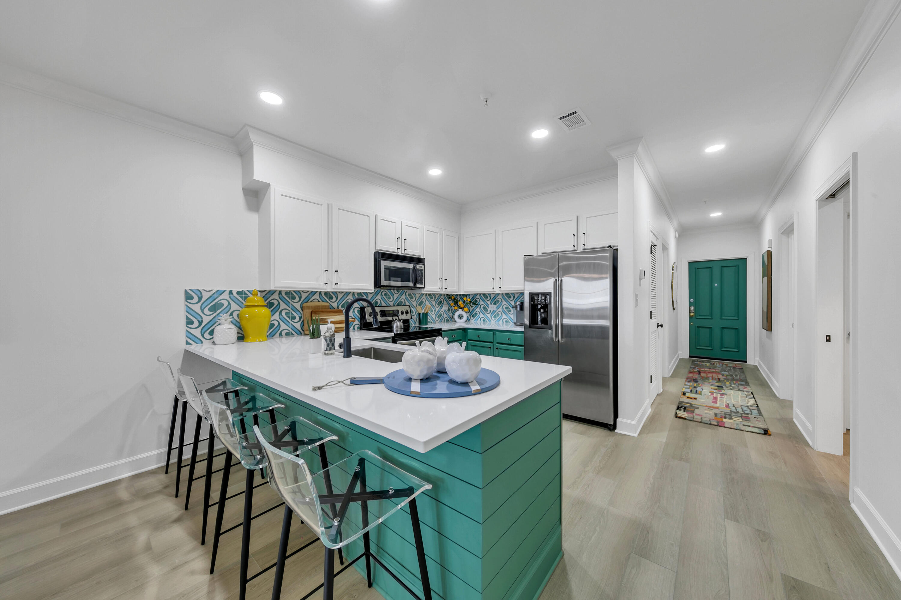 10343 East County Highway 30A, Unit E402 Inlet Beach, FL 32413 - Photo 9 of 34 a kitchen with a dining table cabinets appliances and wooden floor