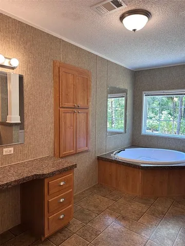 a view of a kitchen with granite countertop cabinets and window