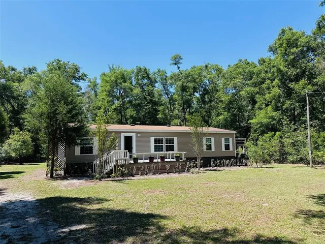 a view of a house with swimming pool and sitting area