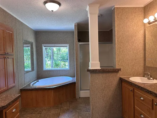 a bathroom with a tub sink and mirror