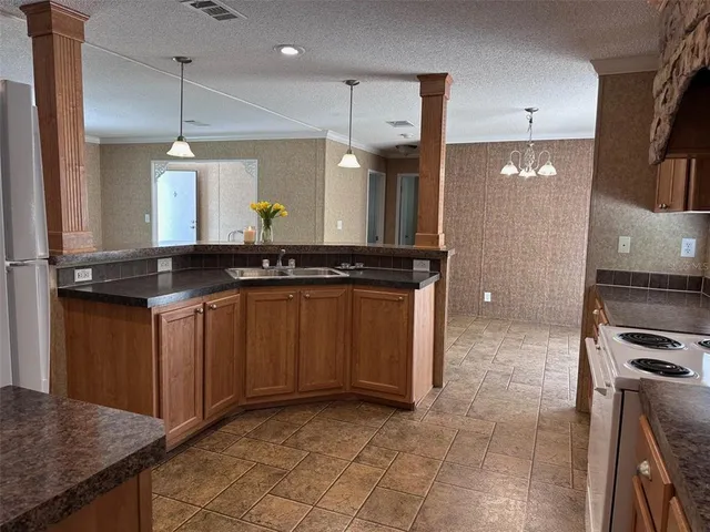 a kitchen with a sink and a stove
