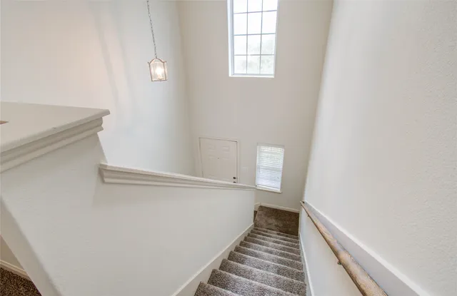 an empty room with fan and windows