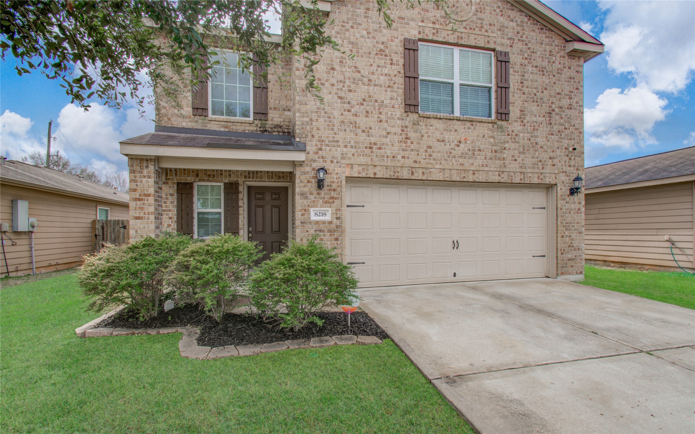8218 Hall View Drive Houston, TX 77075 - Photo 2 of 31 a front view of a house with a garden and yard