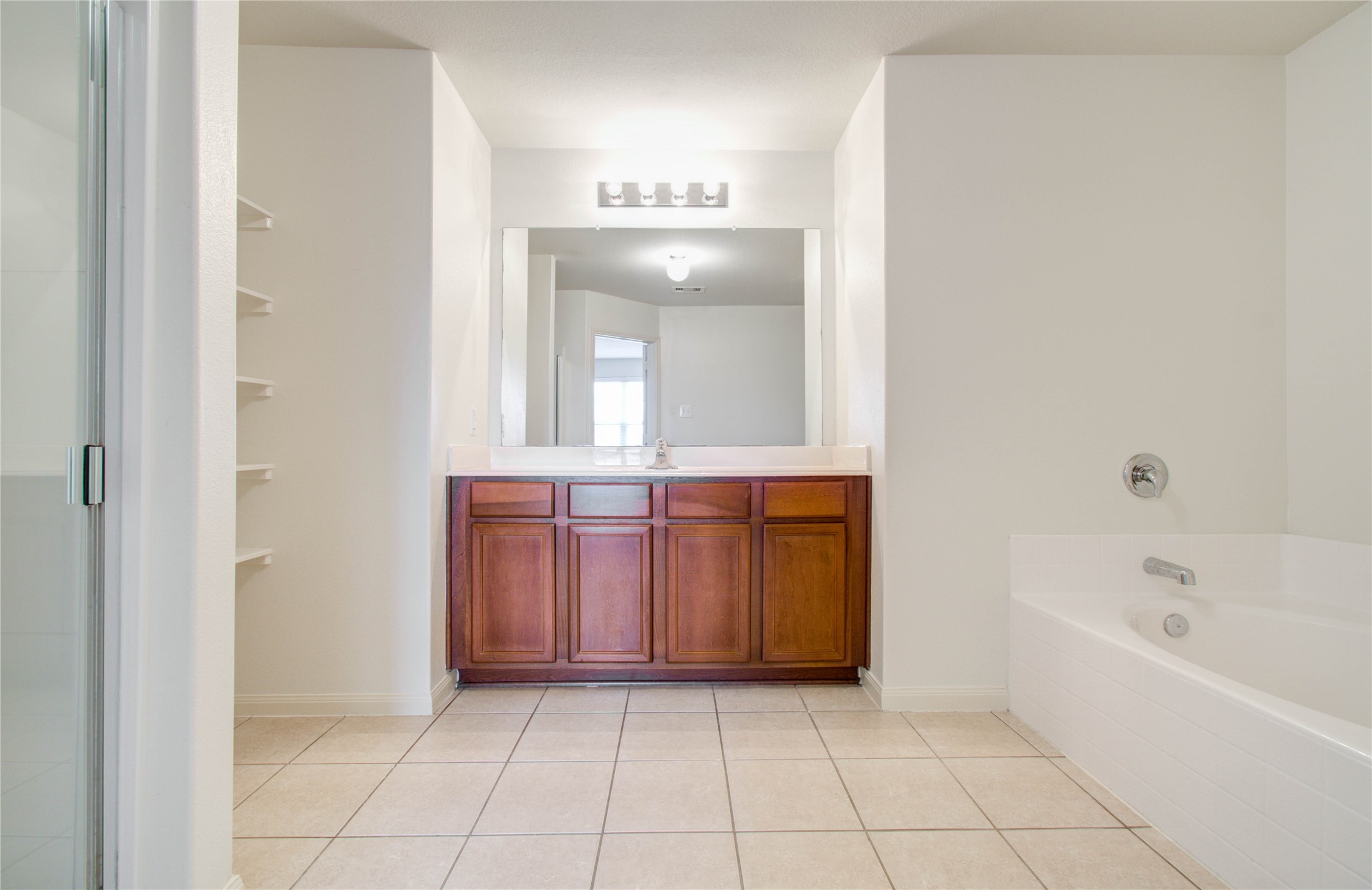 8218 Hall View Drive Houston, TX 77075 - Photo 21 of 31 a spacious bathroom with a bathtub sink and mirror
