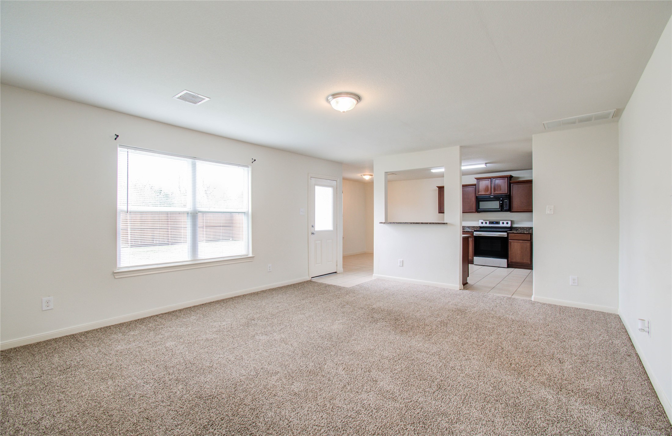 8218 Hall View Drive Houston, TX 77075 - Photo 5 of 31 a view of a kitchen with refrigerator and window