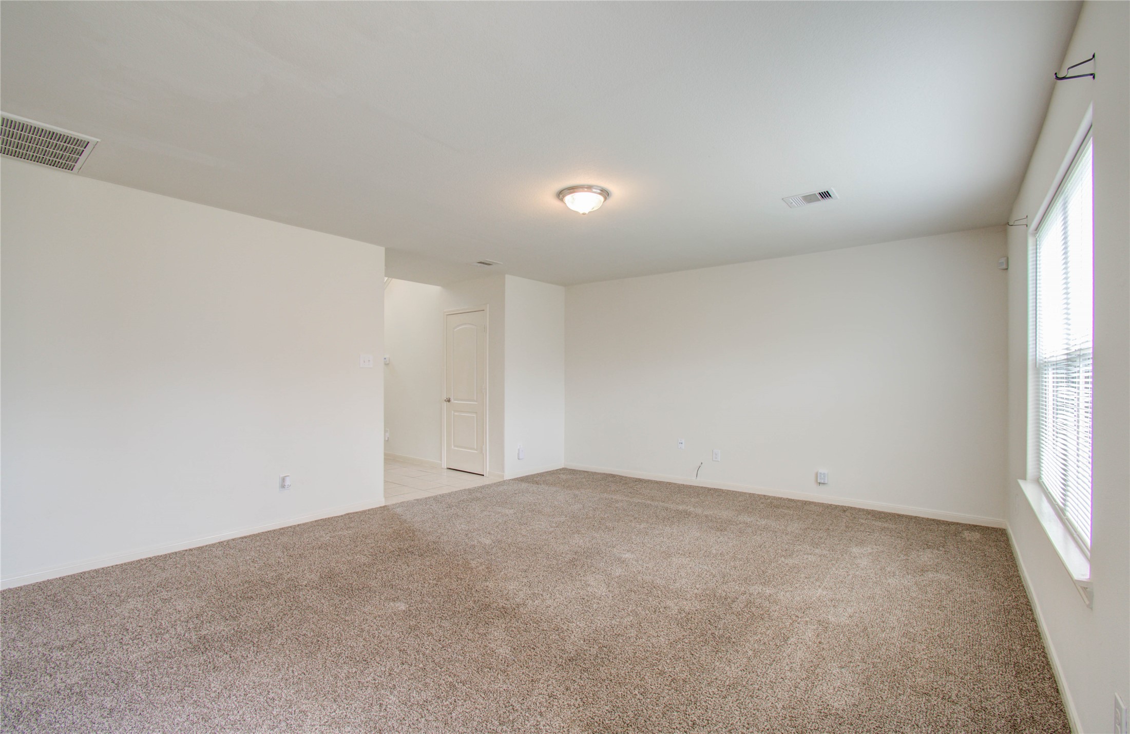 8218 Hall View Drive Houston, TX 77075 - Photo 7 of 31 an empty room with windows