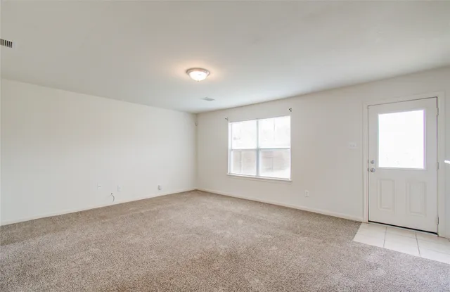 an empty room with a empty space and windows