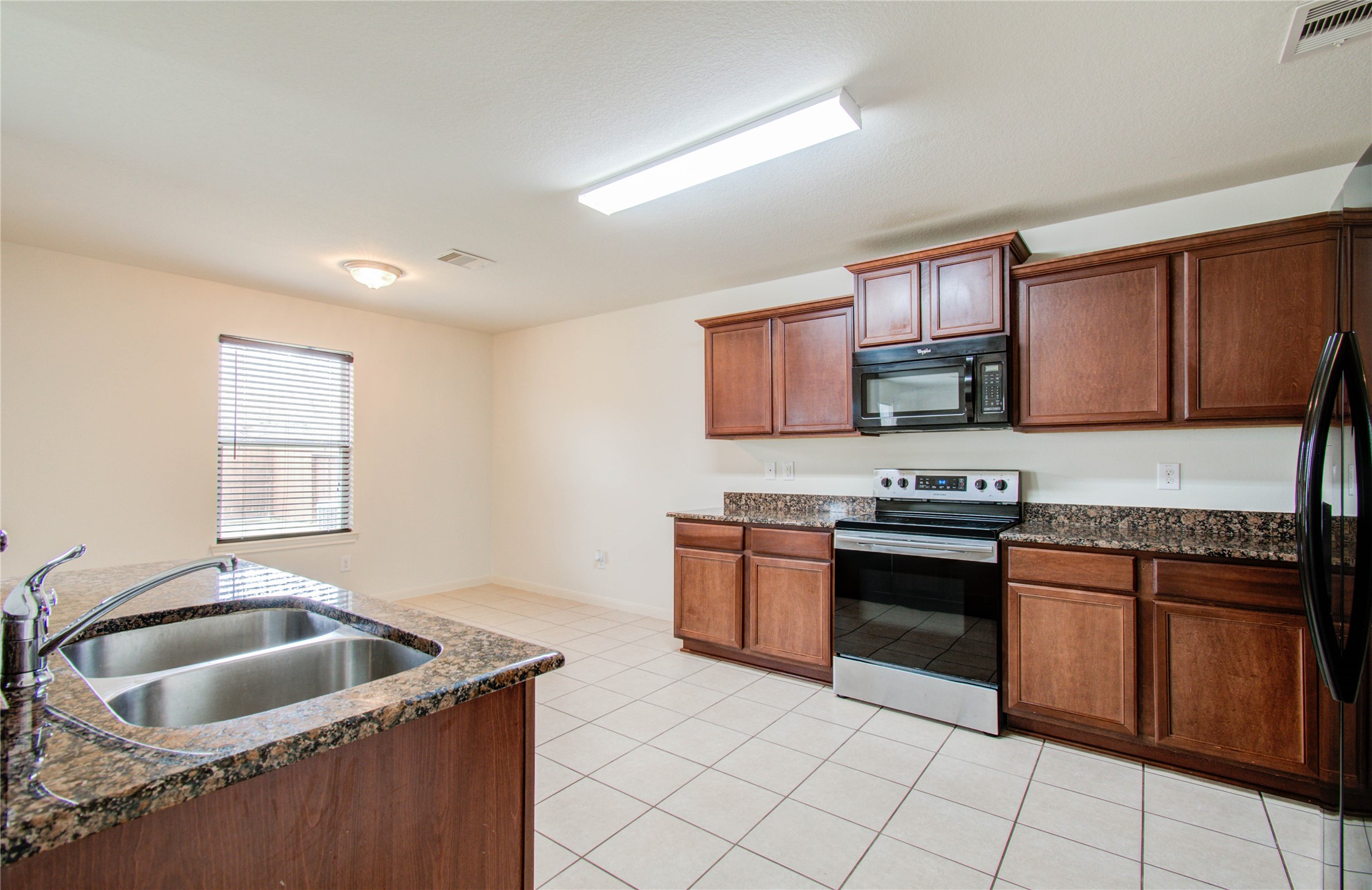 8218 Hall View Drive Houston, TX 77075 - Photo 9 of 31 a kitchen with granite countertop a sink stove top oven and cabinets