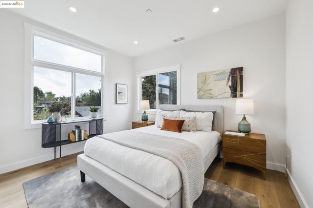 a bedroom with a bed and a large window