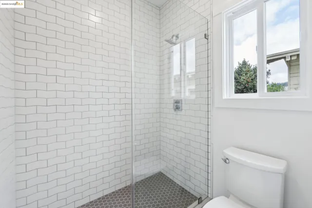 a bathroom with a toilet and a shower