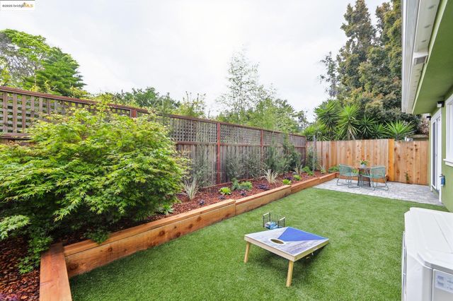a backyard with wooden fence and a bench