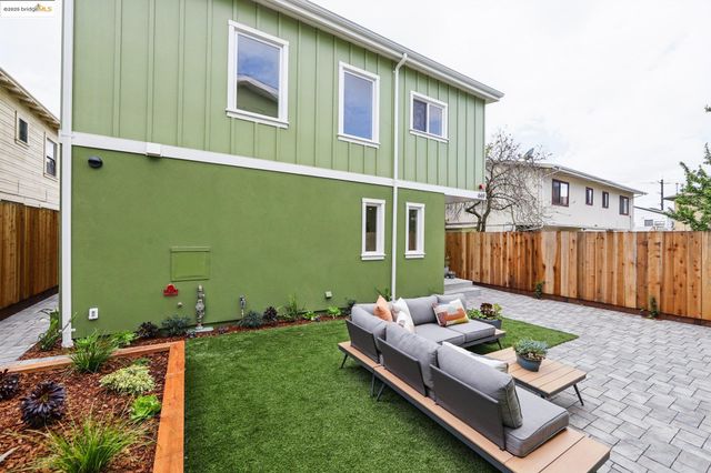 a backyard of a house with table and chairs