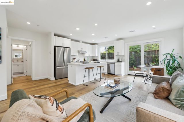 a living room with furniture and kitchen view