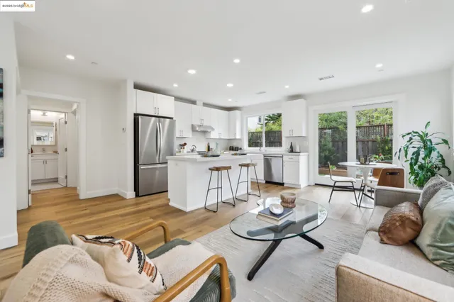a living room with furniture and kitchen view