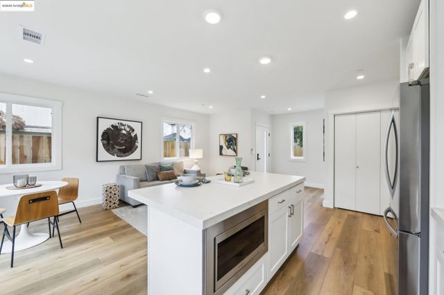 a open kitchen with stainless steel appliances granite countertop a stove and a refrigerator