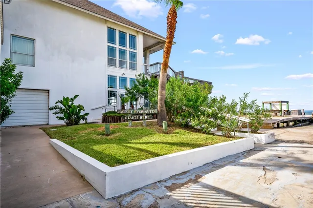 a view of a chairs and table on the wooden roof deck