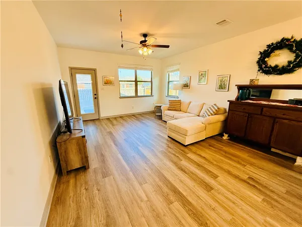 a bedroom with furniture and wooden floor