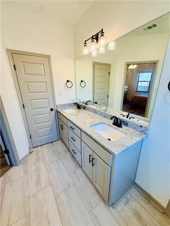 a bathroom with a sink vanity and mirror