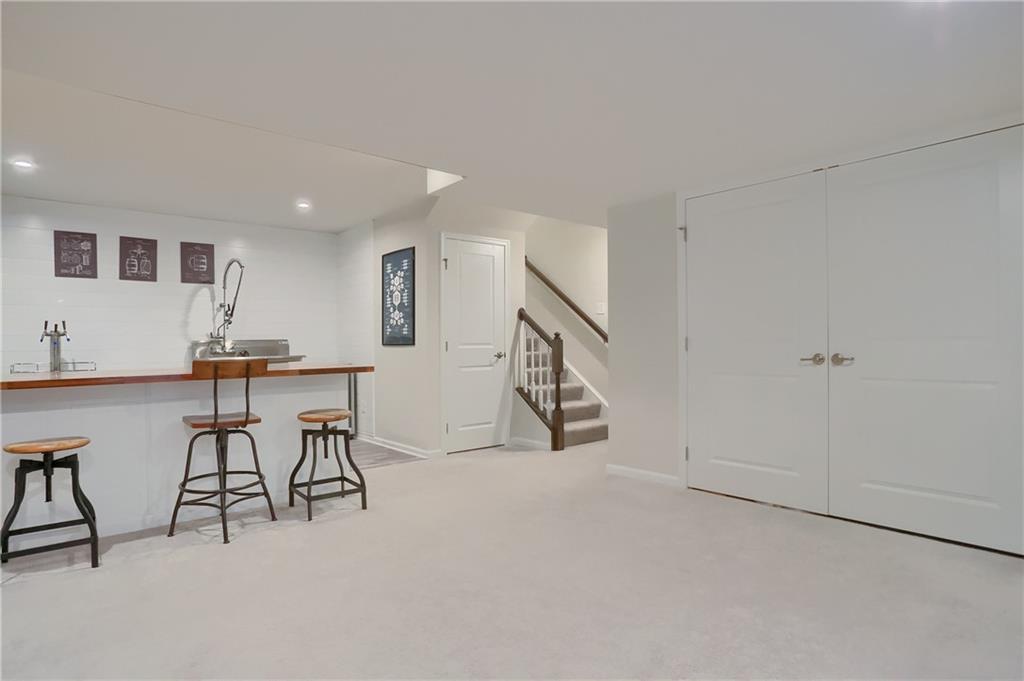 153 Piatt Estates Drive Washington, PA 15301 - Photo 32 of 50 Walk down the stairs to find storage room, full bar, gathering space and full bath! Egress window provides great natural light for the space!