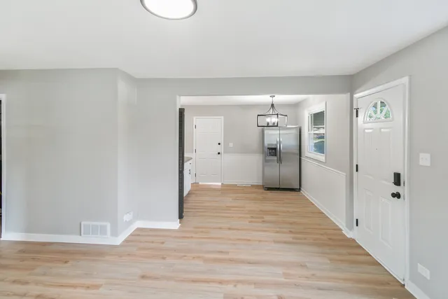 a view of a big room with wooden floor and closet