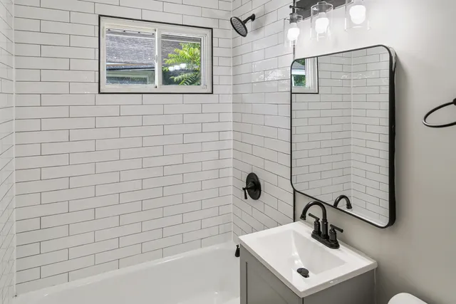 a bathroom with a sink a toilet and mirror
