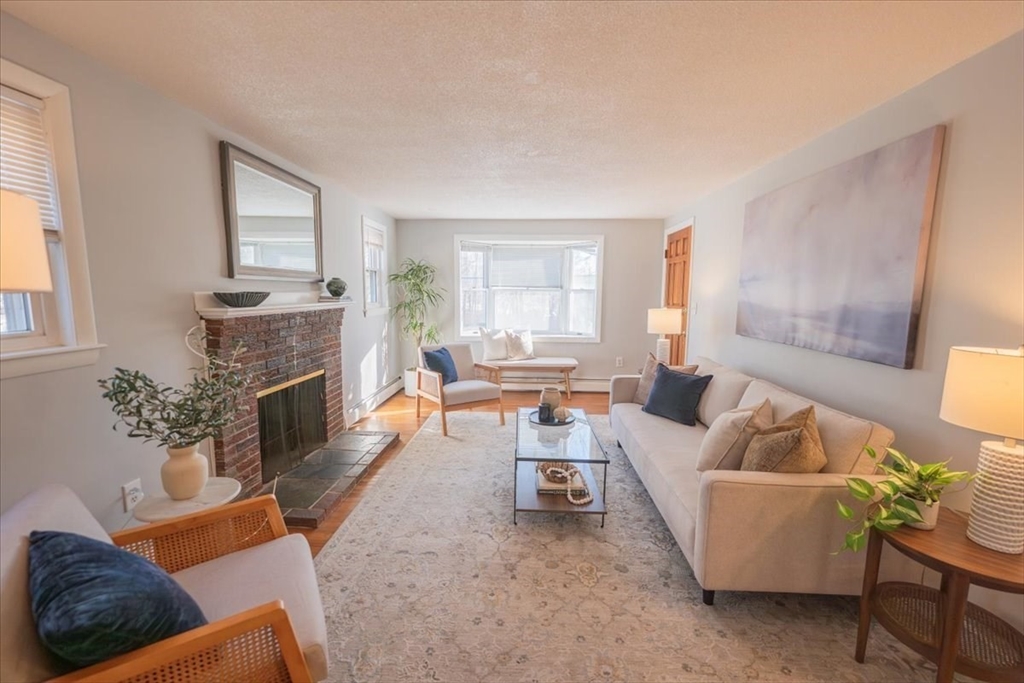 33 Kensington Road Dedham, MA 02026 - Photo 16 of 31 a living room with furniture and a fireplace