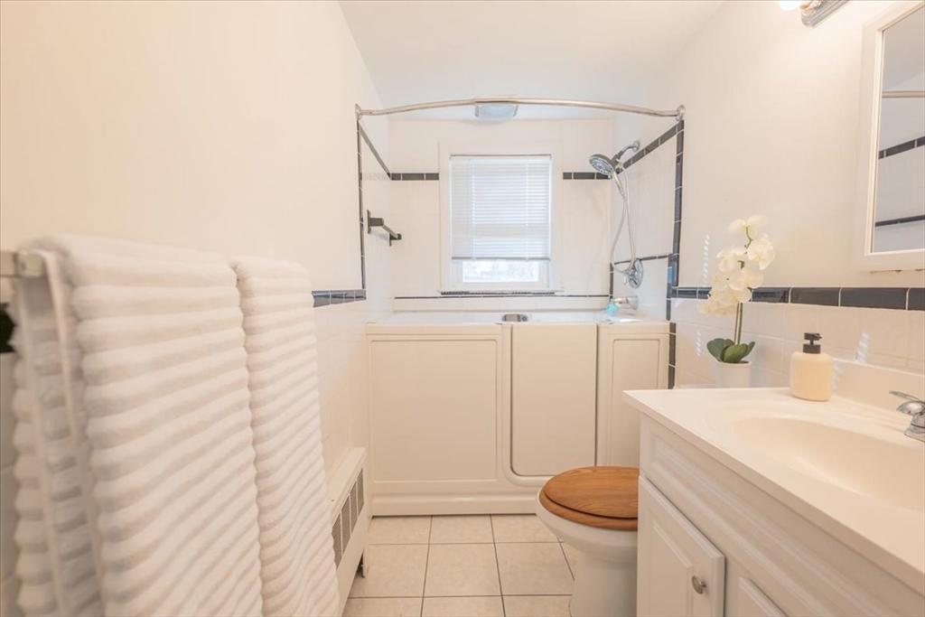 33 Kensington Road Dedham, MA 02026 - Photo 17 of 31 a bathroom with a sink a toilet and shower