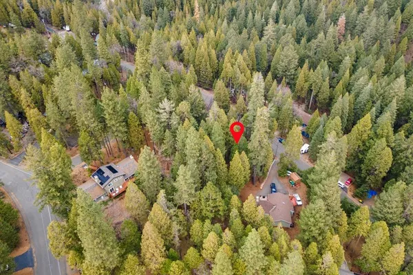 an aerial view of a house with a yard