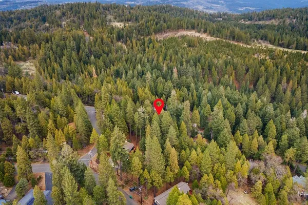 an aerial view of a house with a yard and garden