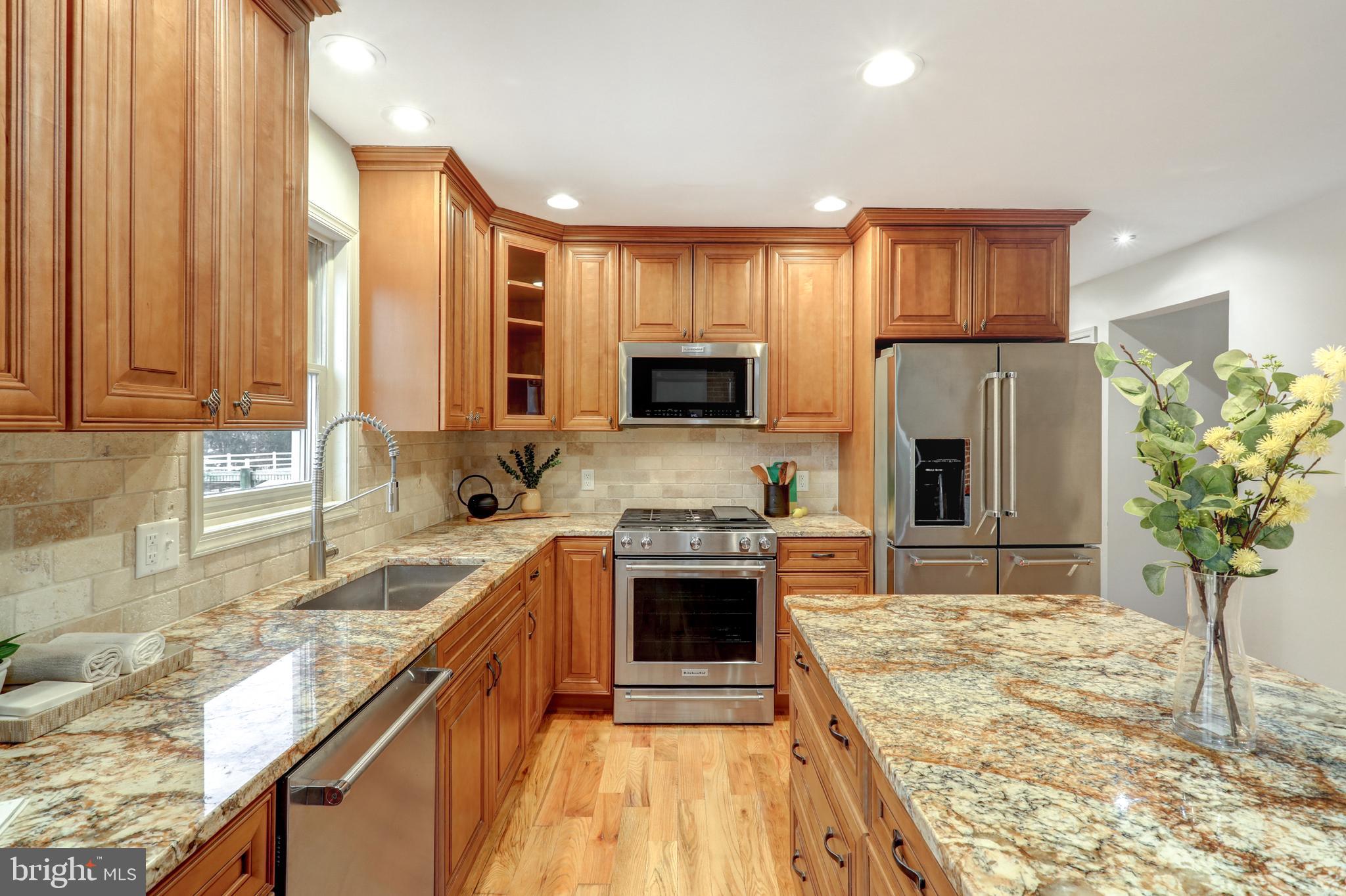 152 Kings Gate Drive Lititz, PA 17543 - Photo 11 of 45 a kitchen with stainless steel appliances granite countertop a refrigerator a stove and a sink